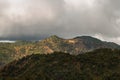 Amazing flowing morning fog mountains range in background with sunlight clouds and sky Royalty Free Stock Photo