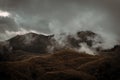 Amazing flowing morning fog mountains range in background with sunlight clouds and sky Royalty Free Stock Photo