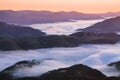 Amazing foggy morning. Sunrise. Landscape with high mountains. Forest of the pine trees. The early morning mist. Touristic place. Royalty Free Stock Photo