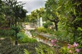 Amazing garden with wooden bridge, chanal, orchards, lush green Royalty Free Stock Photo