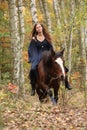 Amazing girl riding a horse without any equipment in autumn fore Royalty Free Stock Photo