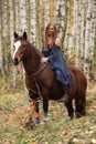 Amazing girl riding a horse without any equipment in autumn fore Royalty Free Stock Photo