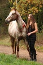 Amazing girl standing next to the appaloosa horse Royalty Free Stock Photo