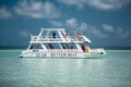 Amazing gorgeous stunning view of glass boat with people on board going in tranquil, azure ocean near the beach on sunny day