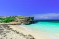 Great inviting view on a cliff sitting in tranquil turquoise ocean and beach against blue sky magic background at Cayo Coco Cuban Royalty Free Stock Photo