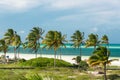 amazing inviting view of tropical white sand beach, ocean and blue sky background