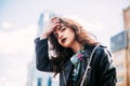 Amazing joyful pretty girl with long brunette hair. posing outdoor. leather jacket,brunette hair, bright red lips Close up fashion Royalty Free Stock Photo