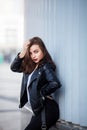 Amazing joyful pretty girl with long brunette hair. posing outdoor. leather jacket,brunette hair, bright red lips Royalty Free Stock Photo