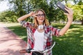 Amazing lady with white headphones posing with pleasure in summer day. Debonair woman making selfie