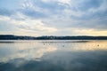 Amazing lake landscape in the evening. Blue yellow cloudy sky with reflection in water at sunset. Nature protection concept. Rural Royalty Free Stock Photo