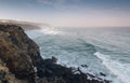 Amazing landscape on the Atlantic ocean at morning. View of the steep slopes of the rocky coast and the foam waves of the ocean. B Royalty Free Stock Photo