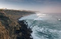 Amazing landscape on the Atlantic ocean at morning. View of the steep slopes of the rocky coast and the foam waves of the ocean. B Royalty Free Stock Photo