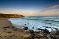 Amazing landscape on the Atlantic ocean at sunrise. View of foamed waves running ashore sandy beach. Concept of nature background Royalty Free Stock Photo