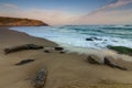 Amazing landscape on the Atlantic ocean at sunrise. View of foamed waves running ashore sandy beach. Concept of nature background Royalty Free Stock Photo