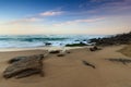 Amazing landscape on the Atlantic ocean at sunrise. View of foamed waves running ashore sandy beach. Concept of nature background Royalty Free Stock Photo