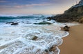 Amazing landscape on the Atlantic ocean at sunrise. View of foamed waves running ashore sandy beach. Concept of nature background Royalty Free Stock Photo