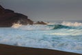 Amazing landscape on the Atlantic ocean at sunrise. View of foamed waves running ashore sandy beach. Concept of nature background. Royalty Free Stock Photo