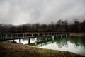 Amazing landscape of bridge reflect on surface water of lake, fog evaporate from pond make romantic scene or Beautiful bridge on l Royalty Free Stock Photo