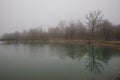 Amazing landscape of bridge reflect on surface water of lake, fog evaporate from pond make romantic scene or Beautiful bridge on l