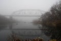 Amazing landscape of bridge reflect on surface water of river, fog evaporate from pond make romantic scene or Beautiful bridge on