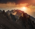 Amazing Landscape of colorful sunset in the mountains. View of mountain range, stony slopes, rocky peaks in sunshine and dramatic Royalty Free Stock Photo