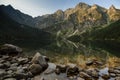 Amazing landscape with high rocks and illuminated peaks, stones in mountain lakeMorskie Oko. Tatra National Park.