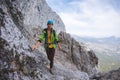 Amazing landscape with a mountain range and a tourist with a backpack in the foreground. mountaineering and climbing