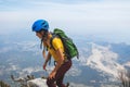 Amazing landscape with a mountain range and a tourist with a backpack in the foreground. mountaineering and climbing