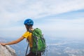 Amazing landscape with a mountain range and a tourist with a backpack in the foreground. mountaineering and climbing