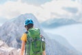 Amazing landscape with a mountain range and a tourist with a backpack in the foreground. mountaineering and climbing