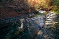 Amazing landscape mountain river in autumn forest at sunlight. View of stone water rapids and small waterfall. Royalty Free Stock Photo