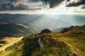 Amazing landscape in the mountains at morning. View of sun rays over hills and valleys. Beam of light from clouds on the mountains Royalty Free Stock Photo