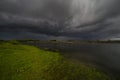 Amazing landscape of nature before thunderstorm. Dark clouds above wild river. Dramatic weather Royalty Free Stock Photo