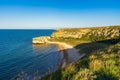 Amazing landscape with sea bay, sand beach and coastal hills and rocks on summer evening at sunset. Trip to seaside. General`s Royalty Free Stock Photo