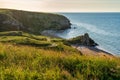 Amazing landscape with sea bay, sand beach and coastal hills and rocks on summer evening at sunset. Trip to seaside. General`s Royalty Free Stock Photo