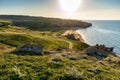 Amazing landscape with sea bay, sand beach and coastal hills and rocks on summer evening at sunset. Trip to seaside. General`s Royalty Free Stock Photo