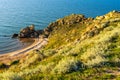 Amazing landscape with sea bay, sand beach and coastal hills and rocks on summer evening at sunset. Trip to seaside. General`s Royalty Free Stock Photo