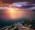 Amazing landscape of sunrise at sea. Colorful morning view of dramatic sky, seascape and rock. Long exposure image. Greece. Medit