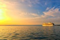 Amazing landscape view of huge large white cruise ship. Panoramic dramatic sunset sky. Ship glides out of the port of Koper. Royalty Free Stock Photo