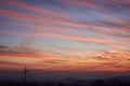 An amazing landscape view at sunrise with red orange blue vivid sky. Natural background with suburbs of the city and beautiful