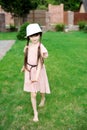 Amazing little girl in pink dress and white hat Royalty Free Stock Photo