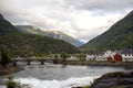 Amazing little wooden small house next to a waterfall on the dock of Hellesylt, child playing in the house