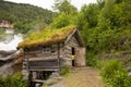 Amazing little wooden small house next to a waterfall on the dock of Hellesylt, child playing in the house