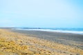 Amazing lonely and wavy beach with colorful sand and rocks