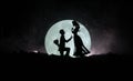 Amazing love scene. Silhouettes of man making proposal to woman or Silhouettes of couple against big moon at background