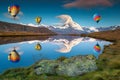 Amazing Matterhorn peak and hot air balloons reflecting in water Royalty Free Stock Photo