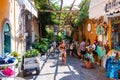 Amazing medieval Positano cityscape on rocky landscape, people and tourists walking by the cozy streets full of art galleries,