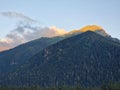 Amazing mountain landscape with colorful bright sunset on cloudy sky, natural outdoor travel background. Coniferous forest in the Royalty Free Stock Photo