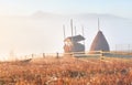 Amazing mountain landscape with fog and a haystack in autumn Royalty Free Stock Photo