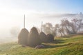 Amazing mountain landscape with fog and a haystack in autumn Royalty Free Stock Photo